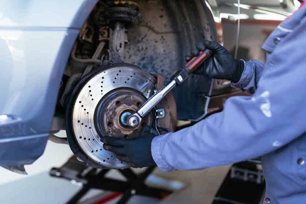 Mechanic repairing car wheel - Mechanics Maitland