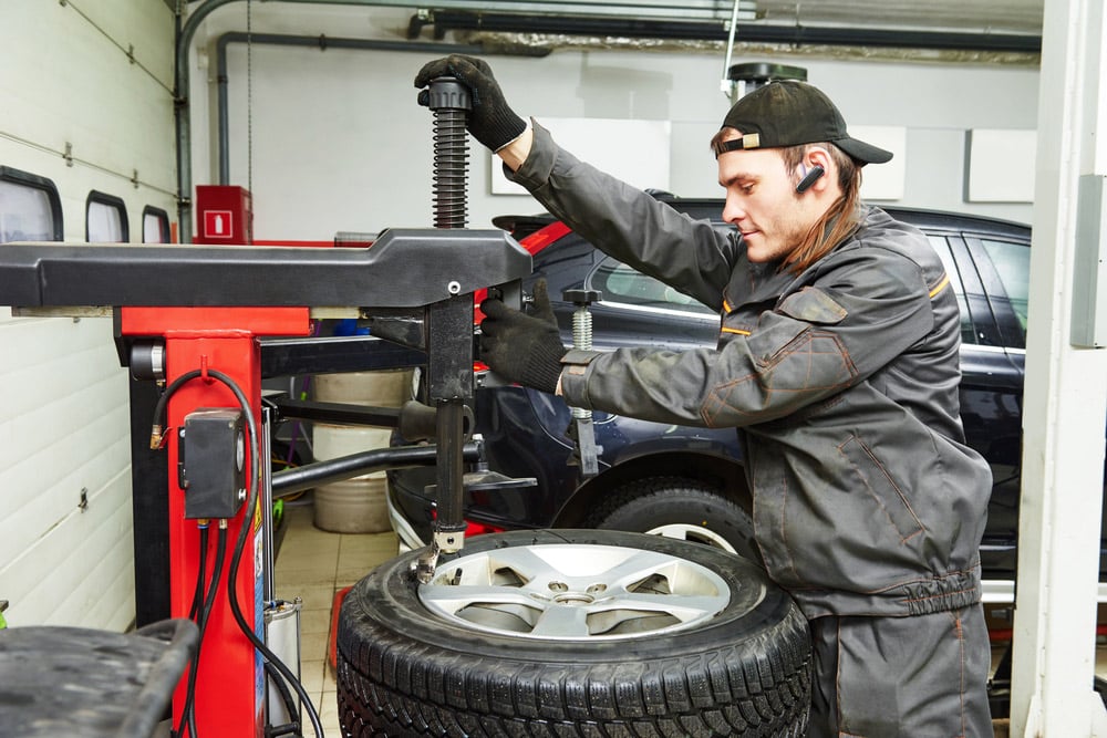 Man Fitting A Tyre