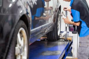 Professional Mechanic Performing A Wheel Alignment